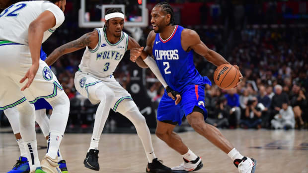 Los Angeles Clippers forward Kawhi Leonard moves the ball against Minnesota Timberwolves forward Jaden McDaniels during the second half at Crypto.com Arena in Los Angeles on Feb. 12, 2024.